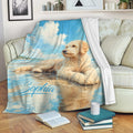 Goldendoodle throw blanket displayed on a sofa with beach, ocean, and blue sky artwork