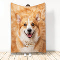 Corgi face blanket displayed upright, featuring warm tan and white dog artwork