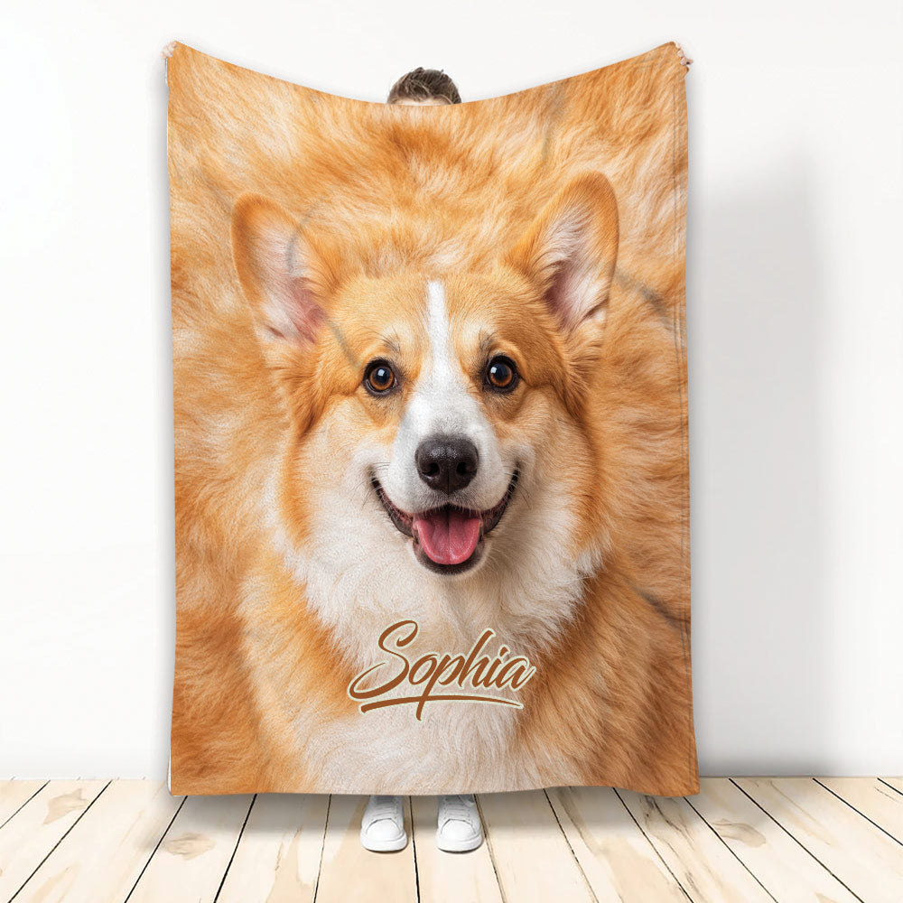 Corgi face blanket displayed upright, featuring warm tan and white dog artwork