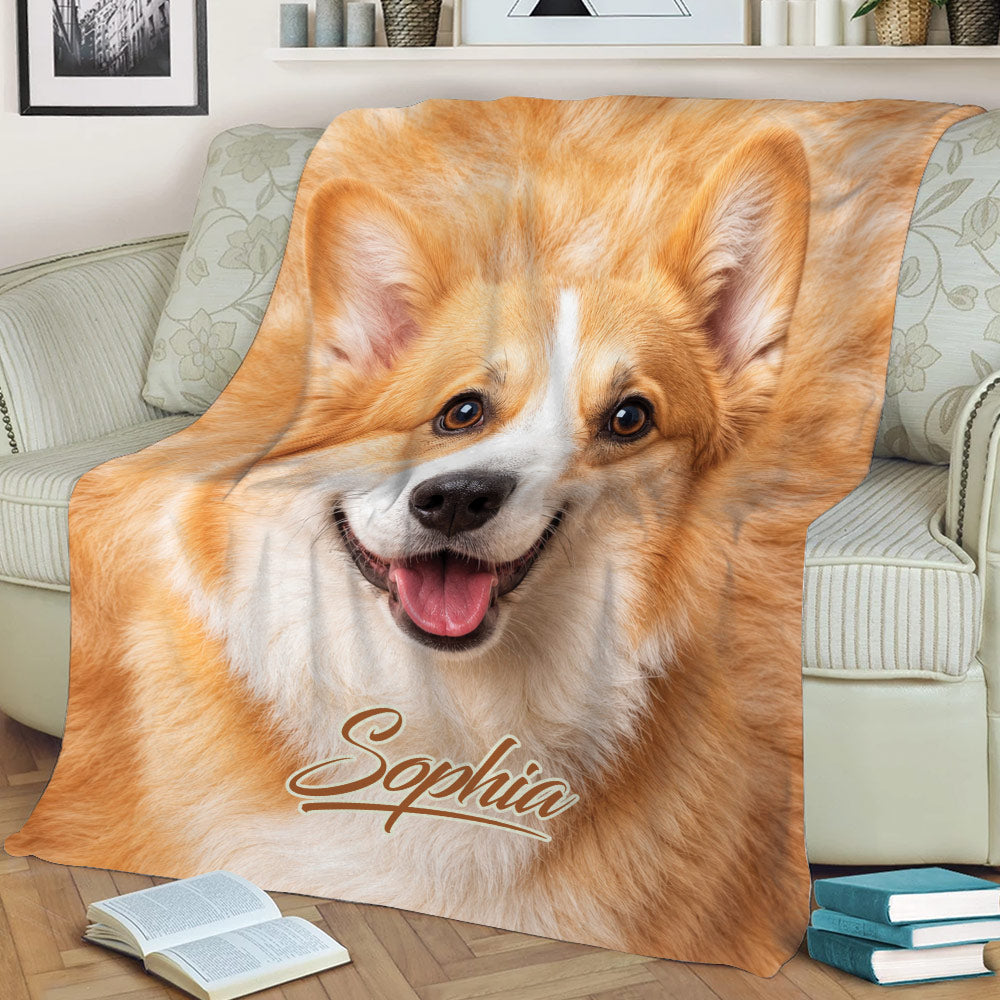 Close view of a smiling Corgi throw blanket styled over a living room sofa