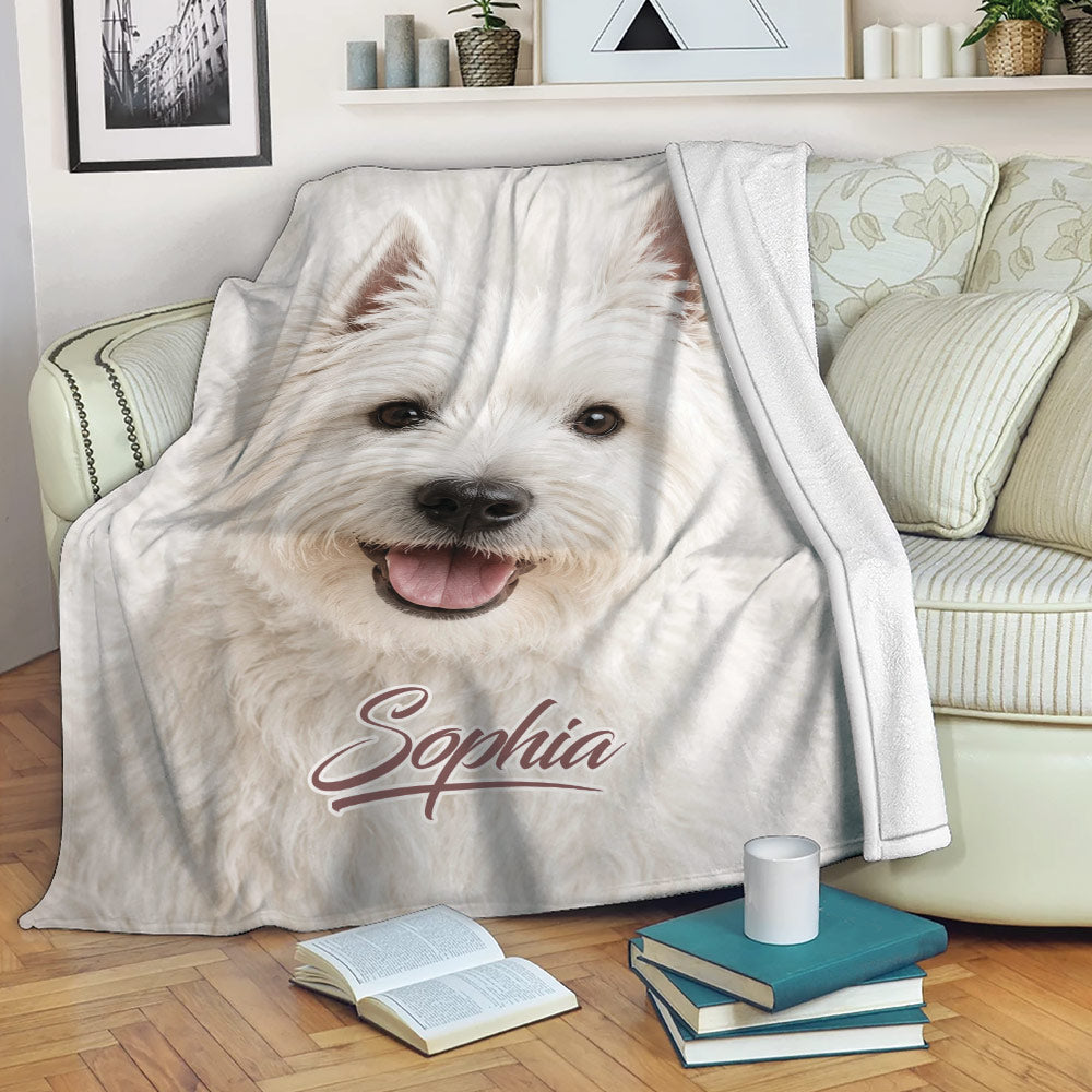 Westie throw blanket draped over a sofa, showing a cheerful white terrier design in a cozy living room