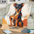 Geometric Miniature Pinscher blanket draped over a sofa with colorful angular dog artwork