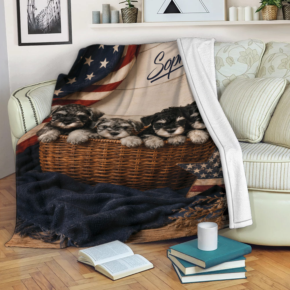 Miniature Schnauzer throw blanket displayed on a couch with four puppies, rustic wood, and patriotic flag details