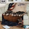 Close view of a Miniature Schnauzer puppy blanket draped over a sofa with basket artwork and American flag accents