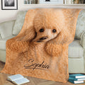 Curly poodle blanket draped over a sofa, showcasing warm apricot dog artwork