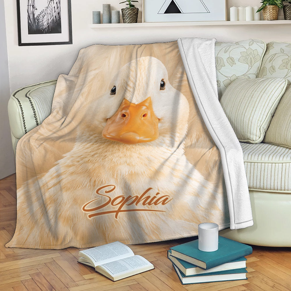 White duck throw blanket draped over a sofa in a cozy living room setting