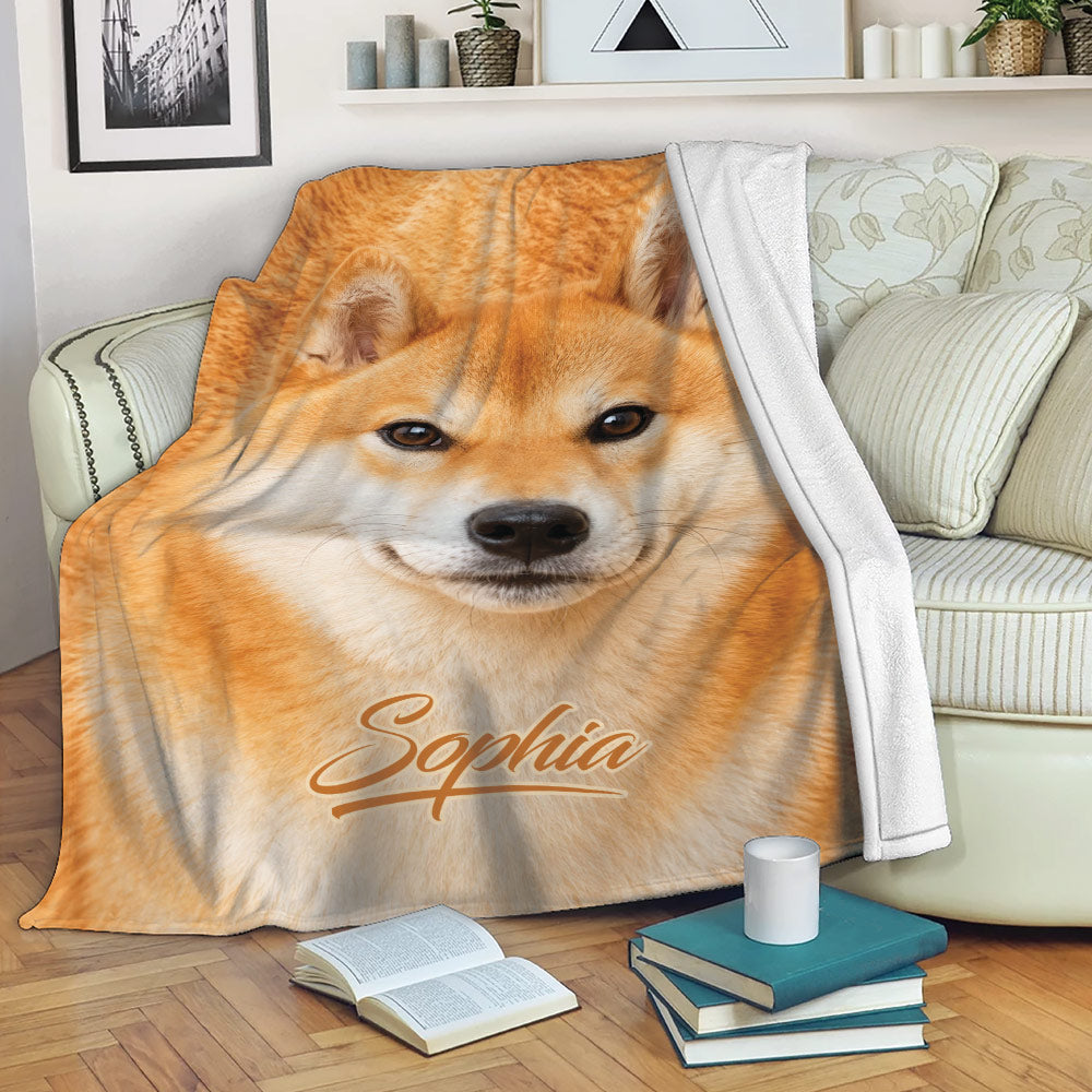 Shiba Inu blanket draped over a sofa in a cozy living room setting