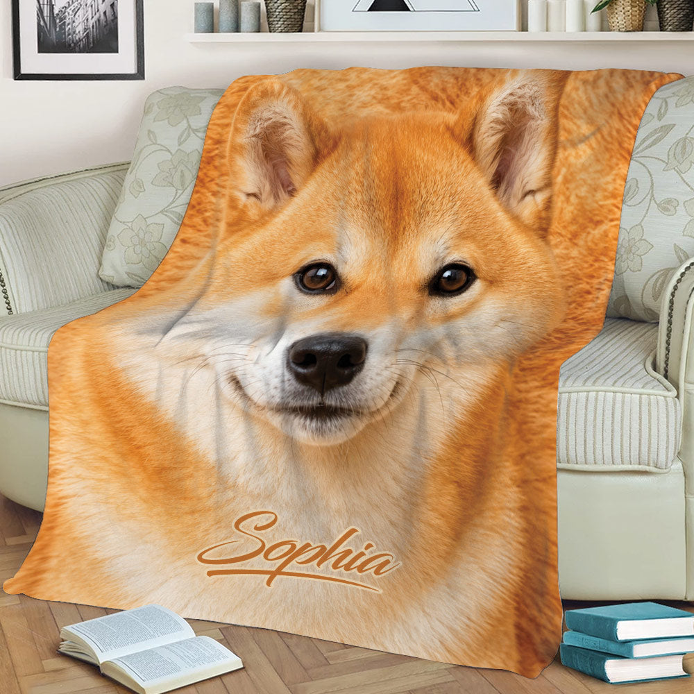 Close-up Shiba Inu throw blanket styled on a sofa with books nearby
