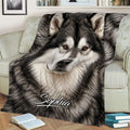 Close view of an Alaskan Malamute throw blanket displaying detailed black and white dog artwork
