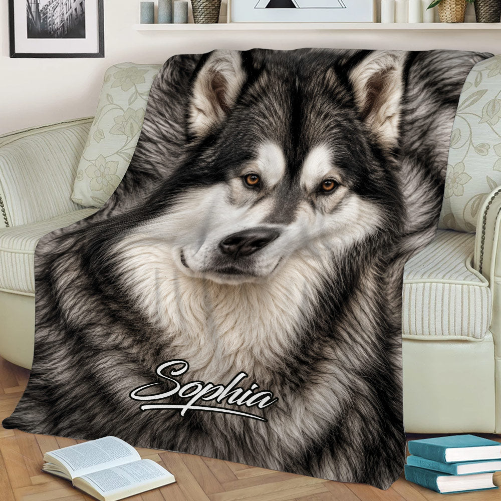 Close view of an Alaskan Malamute throw blanket displaying detailed black and white dog artwork