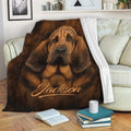 Bloodhound blanket draped over a sofa in a cozy living room with realistic brown dog artwork