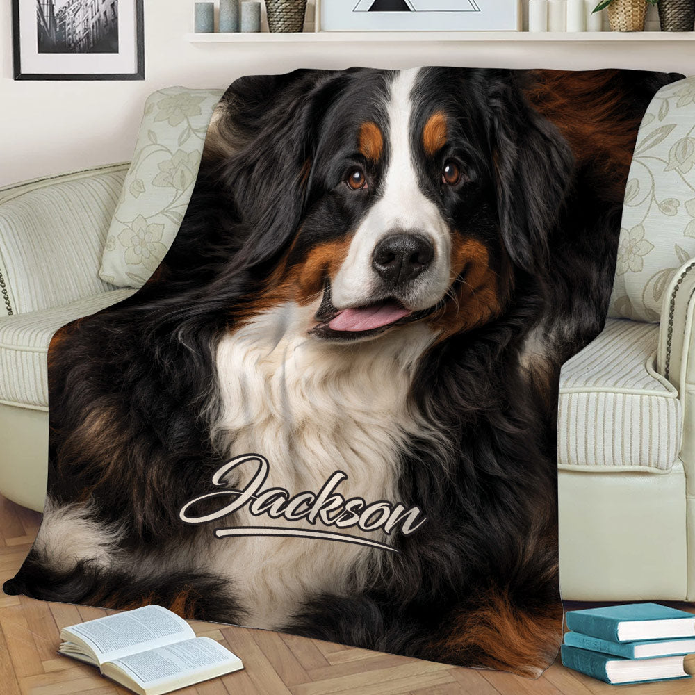 Close-up Bernese Mountain Dog throw blanket styled on a sofa with books nearby