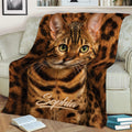 Close view of a Bengal cat blanket with expressive green eyes and spotted fur artwork