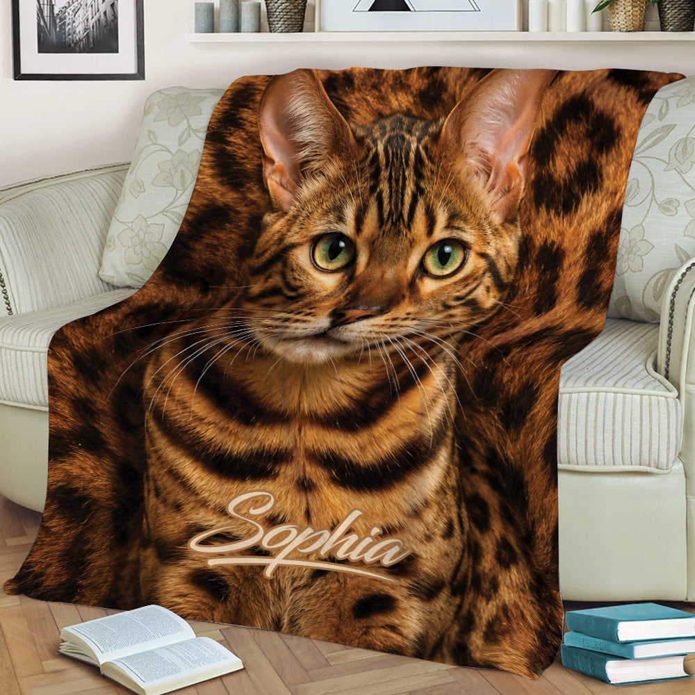 Close view of a Bengal cat blanket with expressive green eyes and spotted fur artwork
