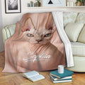 Sphynx cat blanket draped over a sofa with expressive hairless cat artwork in a cozy living room