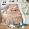 Persian cat blanket draped over a sofa, featuring a fluffy cream cat in a cozy living room