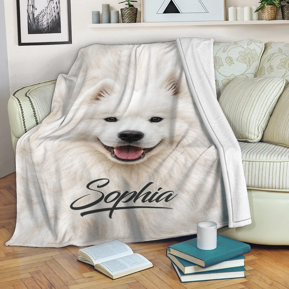 Samoyed throw blanket draped over a sofa, featuring a smiling white dog artwork