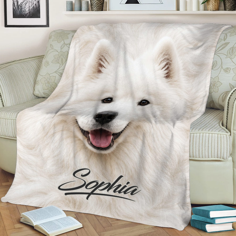 Large white Samoyed artwork on a throw blanket styled over a living room couch