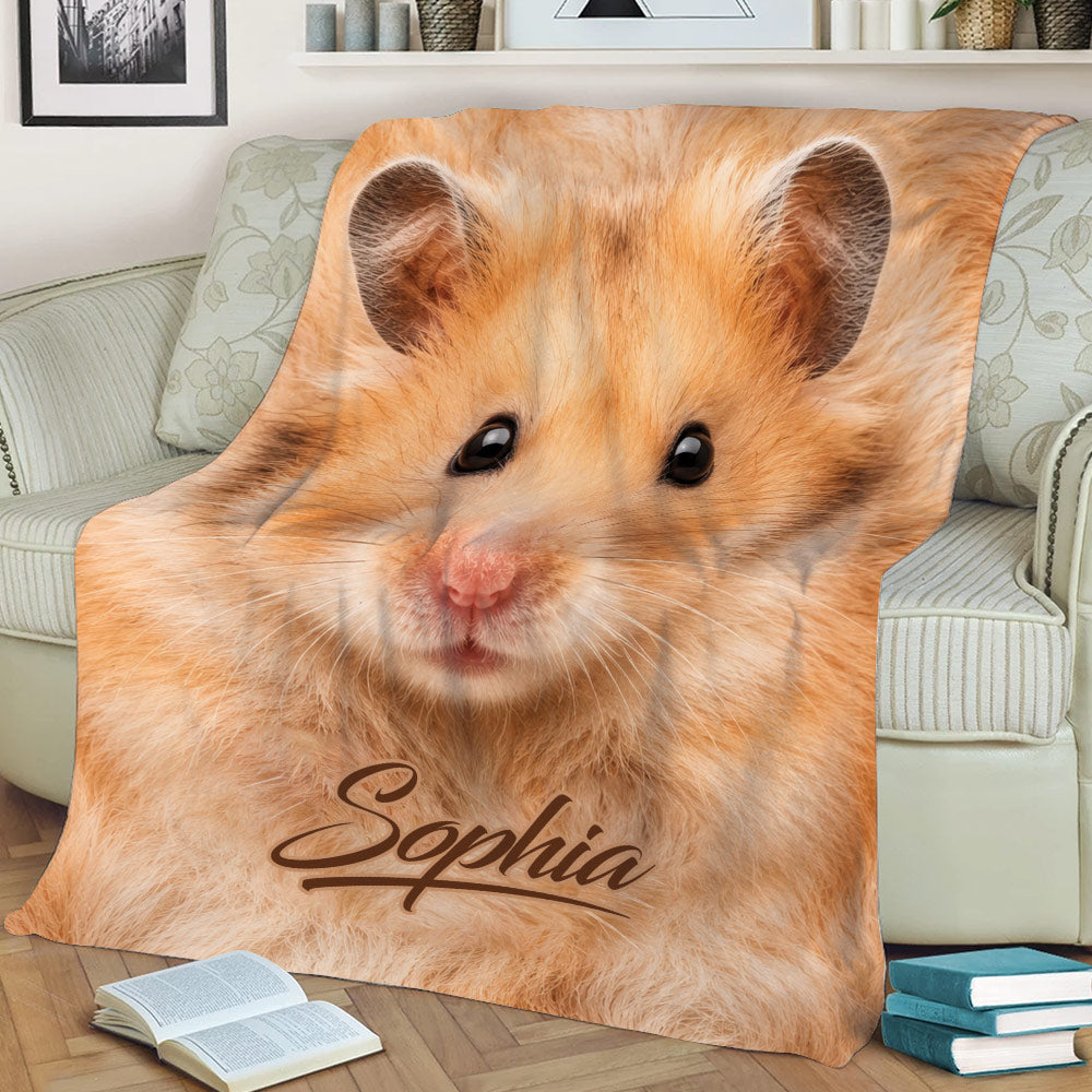 Close-up golden hamster blanket styled on a sofa with books nearby