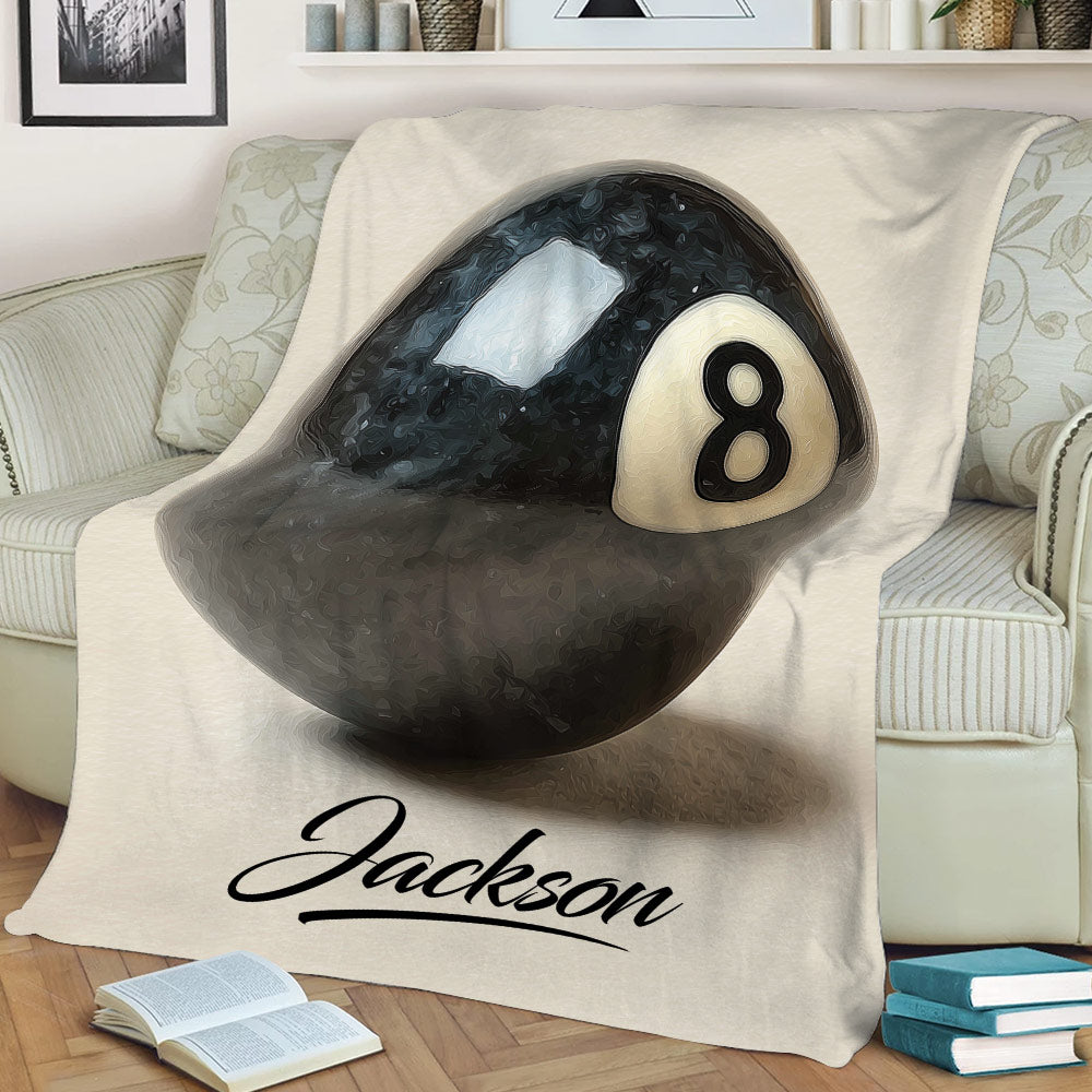 Close-up billiard throw blanket showing a detailed black 8-ball design on a sofa