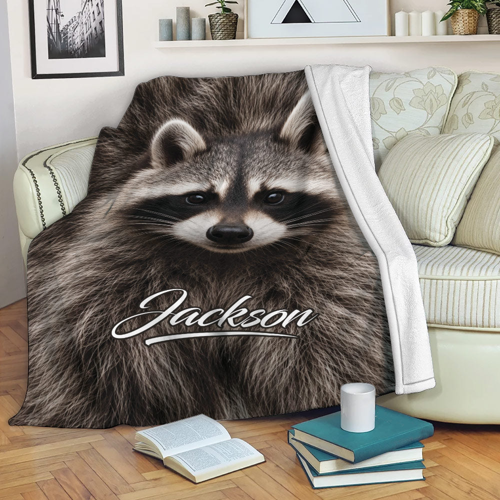 Raccoon throw blanket draped over a sofa in a cozy living room setting
