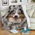 Australian Shepherd blanket draped over a sofa with realistic dog artwork in a cozy living room