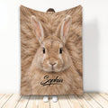 Rabbit face blanket with warm tan fur artwork displayed in a full-length indoor lifestyle setting