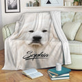 Great Pyrenees throw blanket draped over a sofa with white dog artwork