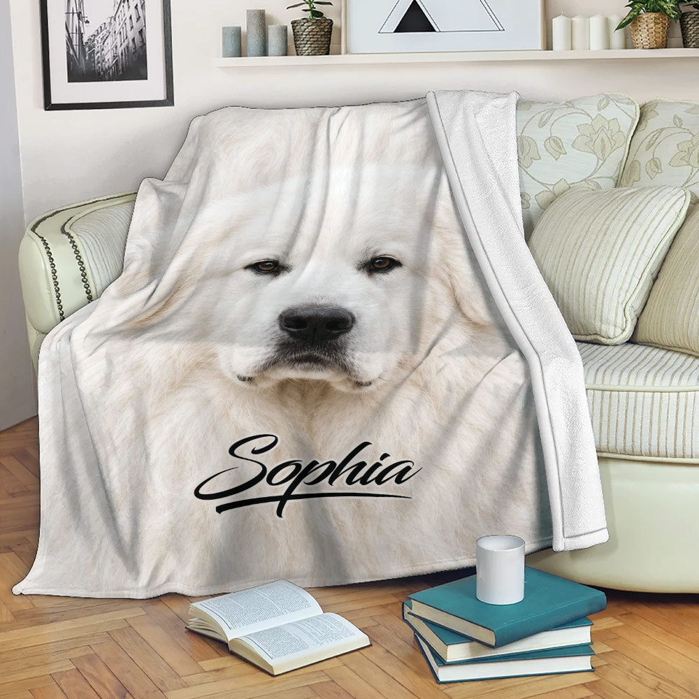 Great Pyrenees throw blanket draped over a sofa with white dog artwork