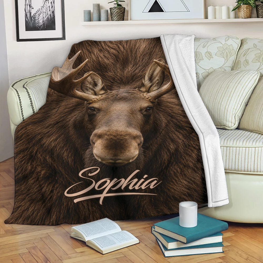 Realistic moose throw blanket draped over a sofa in a cozy living room setting