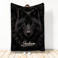 Black wolf throw blanket displayed upright with dramatic wildlife artwork