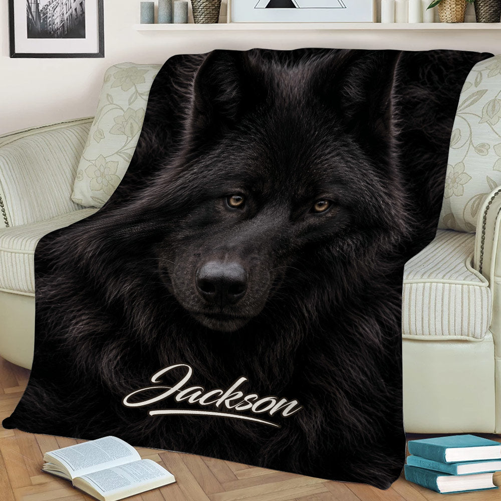 Close view of black wolf artwork on a throw blanket styled on a sofa