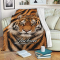 Tiger blanket draped across a sofa with striking orange and black wildlife artwork