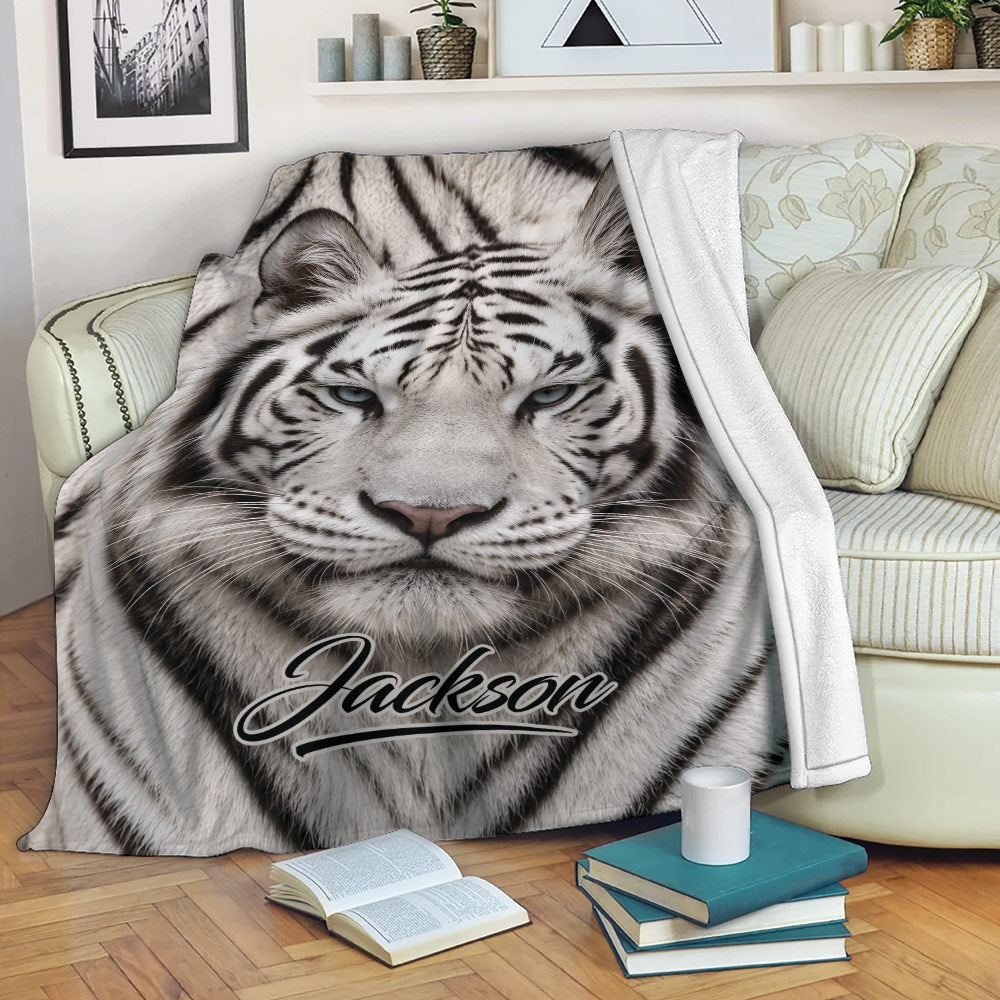 Tiger throw blanket draped over a sofa with bold striped wildlife artwork in a cozy reading space