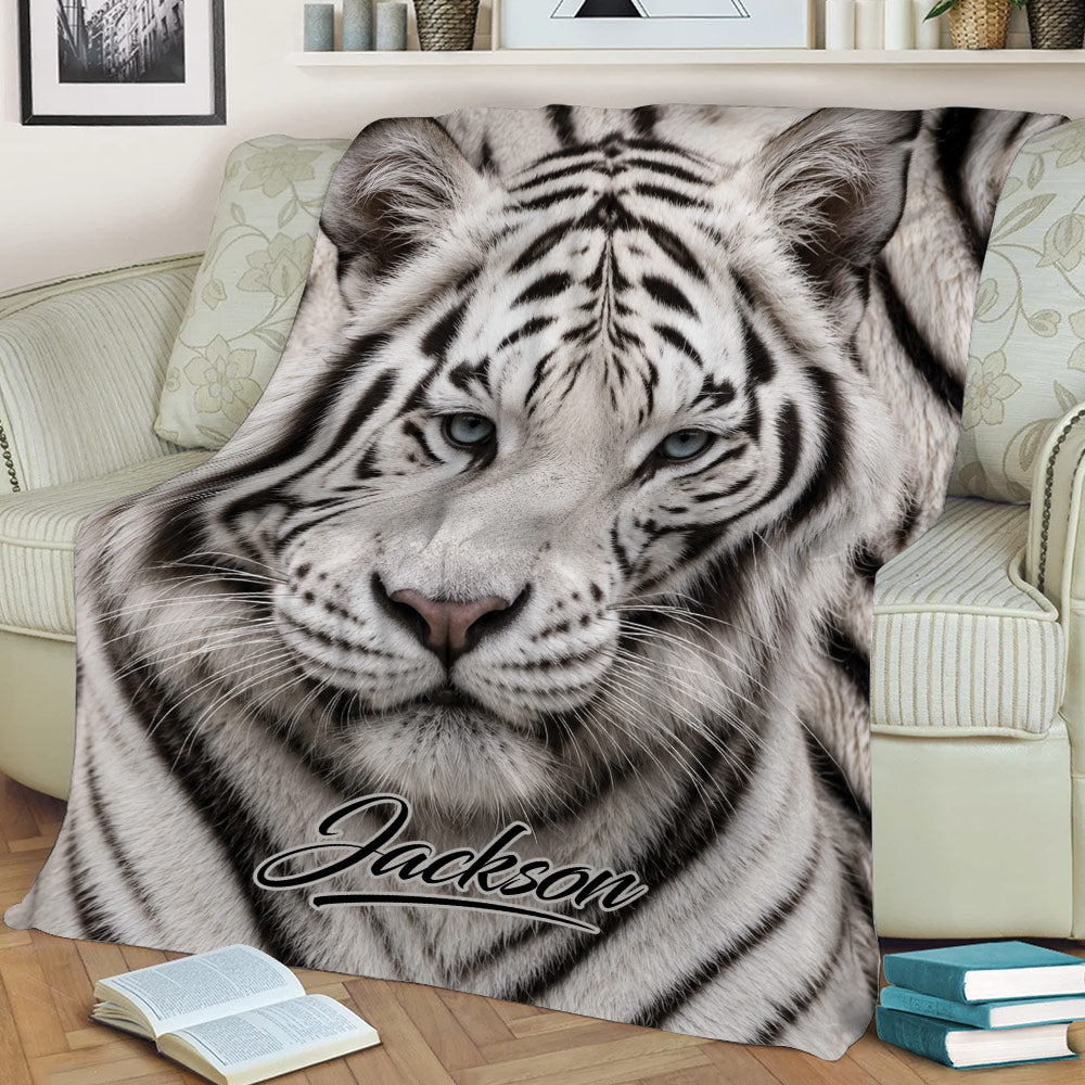 Close-up tiger throw blanket displayed across a sofa, featuring realistic eyes and detailed striped fur