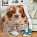 Brittany Spaniel blanket draped across a cozy sofa in a warm living room setting