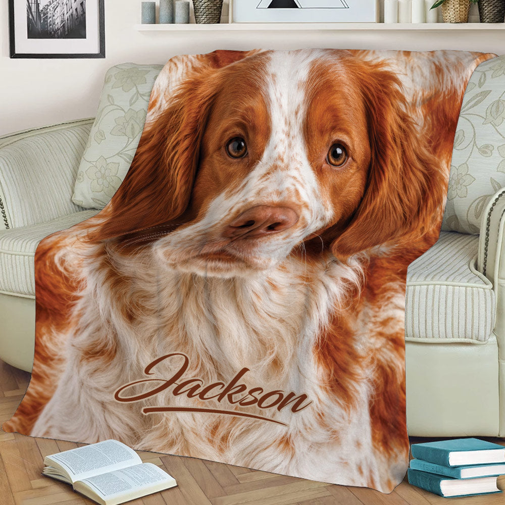 Brittany Spaniel throw blanket displayed on an armchair with a close-up dog design