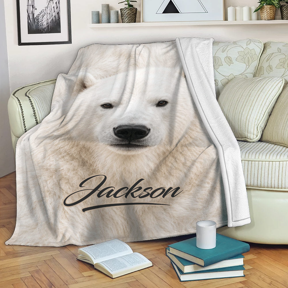 Polar bear blanket draped over a sofa with cozy reading nook decor