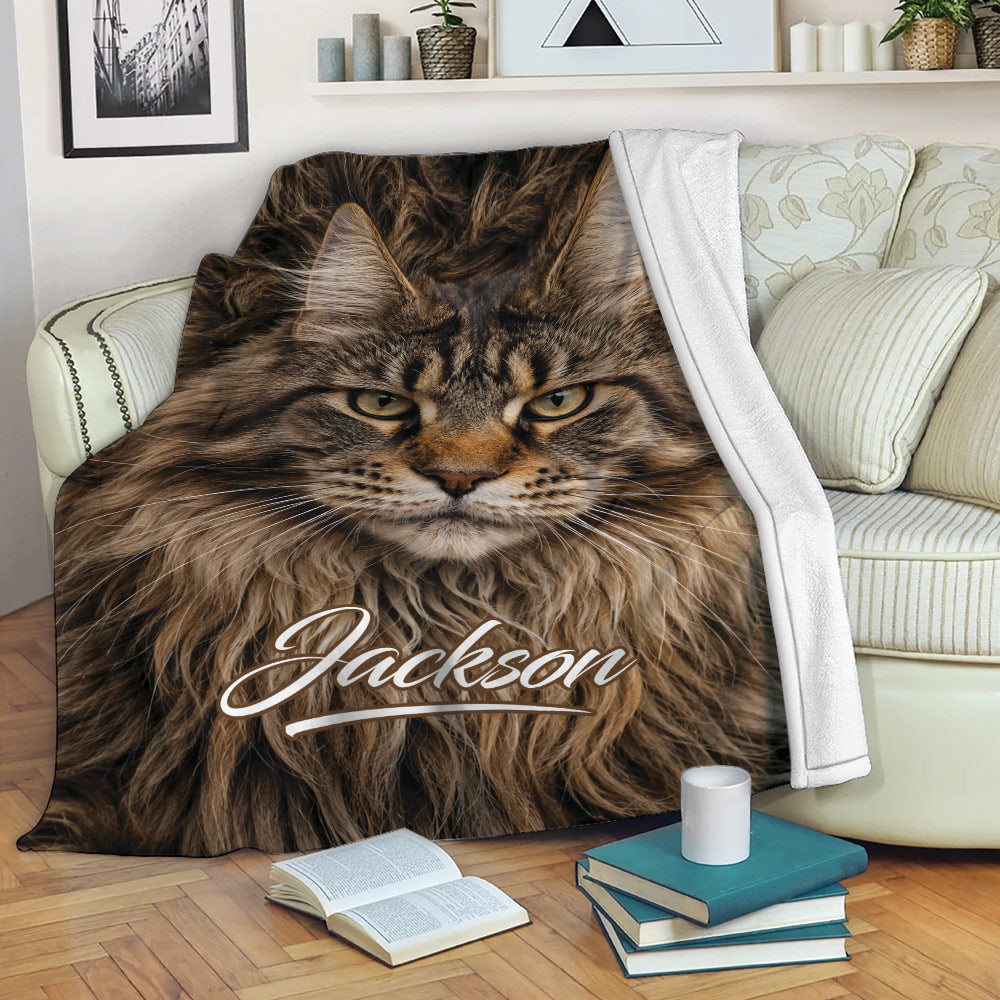 Maine Coon cat throw blanket draped over a sofa in a cozy living room setting