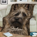 Close-up Cairn Terrier throw blanket styled across a sofa with warm brown dog artwork