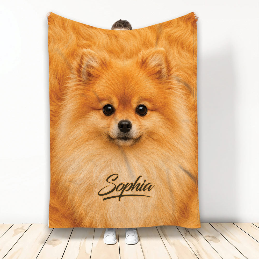 Fluffy orange Pomeranian throw blanket displayed upright with a close-up dog design