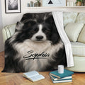 Border Collie throw blanket draped over a sofa with a realistic black-and-white dog design