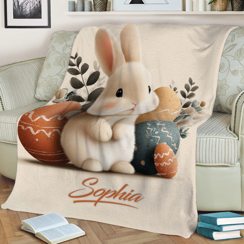 Close view of a rabbit throw blanket featuring a soft bunny, Easter eggs, and leafy accents