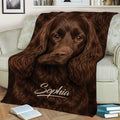 Brown Boykin Spaniel blanket displayed on a couch with detailed long-haired dog artwork
