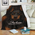 Black and tan Doberman throw blanket draped over a sofa in a cozy living room