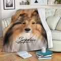 Sheltie blanket draped over a sofa, featuring a realistic sable Shetland Sheepdog artwork