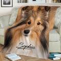 Cozy Sheltie throw blanket displayed on a sofa with a detailed Shetland Sheepdog face design