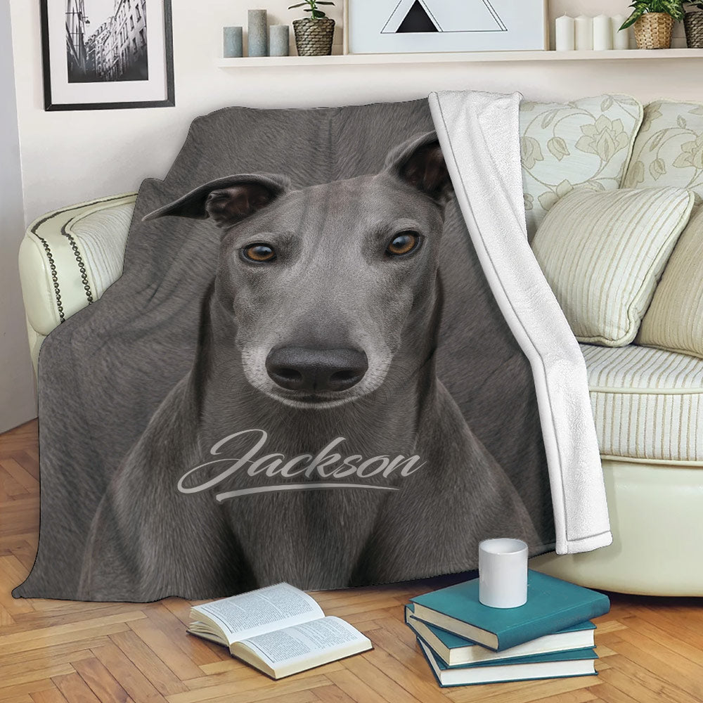 Greyhound throw blanket draped over a sofa with realistic gray dog artwork in a cozy living room