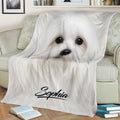 Close view of a Maltese dog throw blanket styled across a sofa