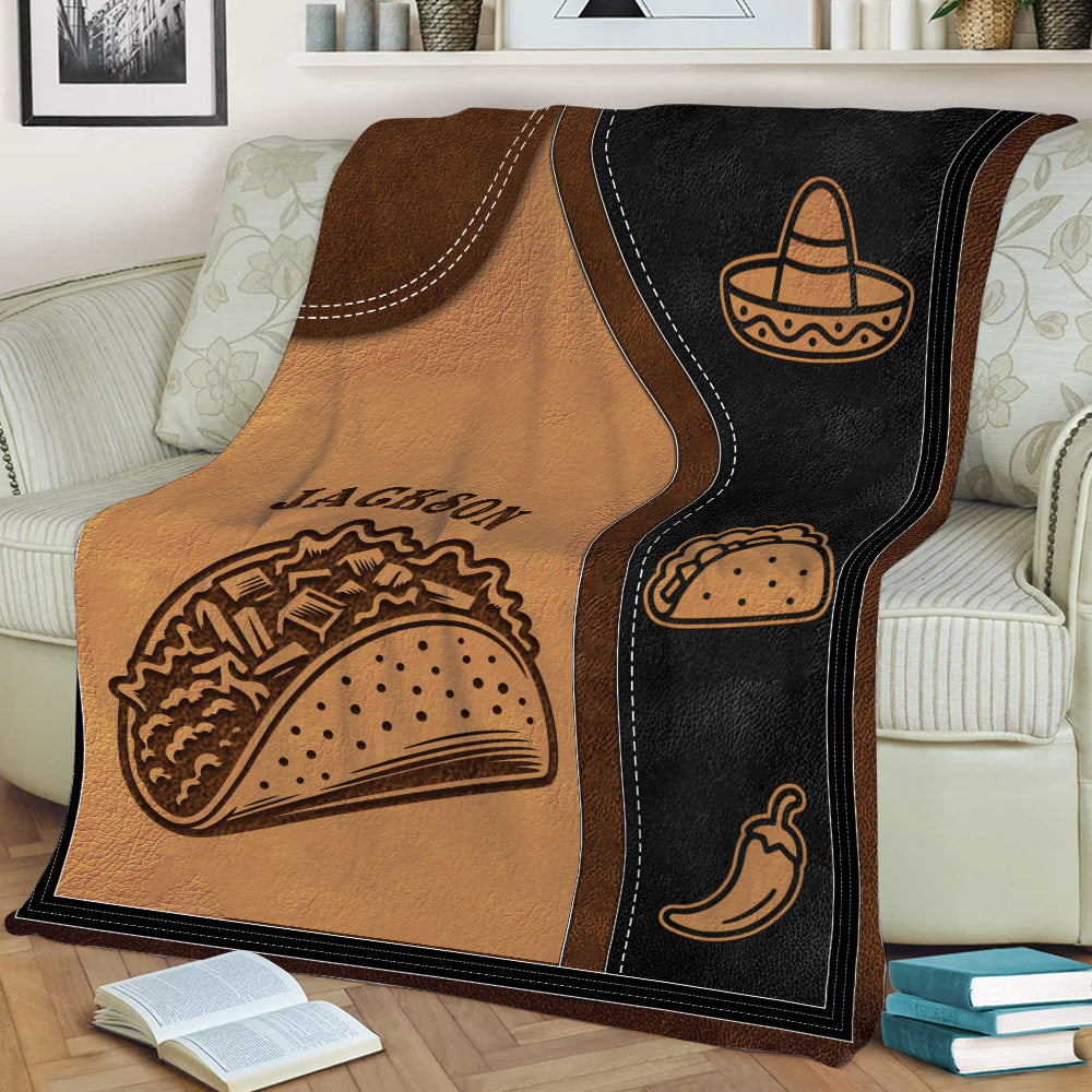 Close view of taco blanket design with illustrated hard-shell tacos, sombrero icon, and rustic brown decor